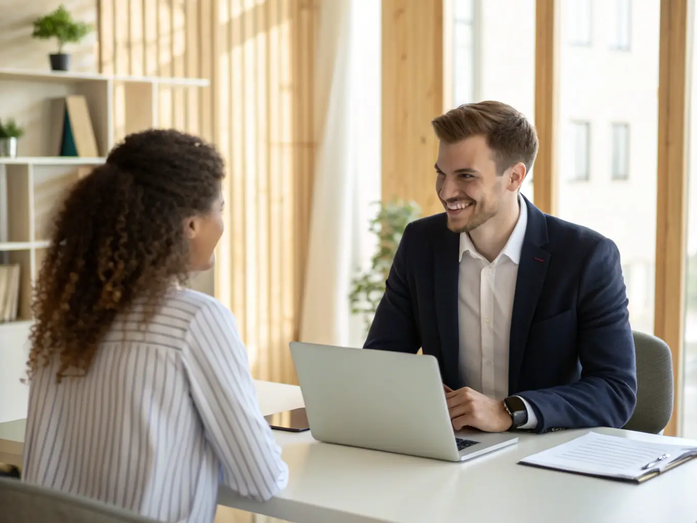 A professional recruiter conducting an interview with a candidate in a modern office setting, symbolizing HR Partnerzy's Permanent Recruitment service.