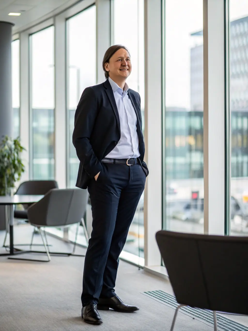 A professional candidate portrait, smiling confidently, ready for an interview, set against a modern office background, symbolizing career readiness and opportunity.